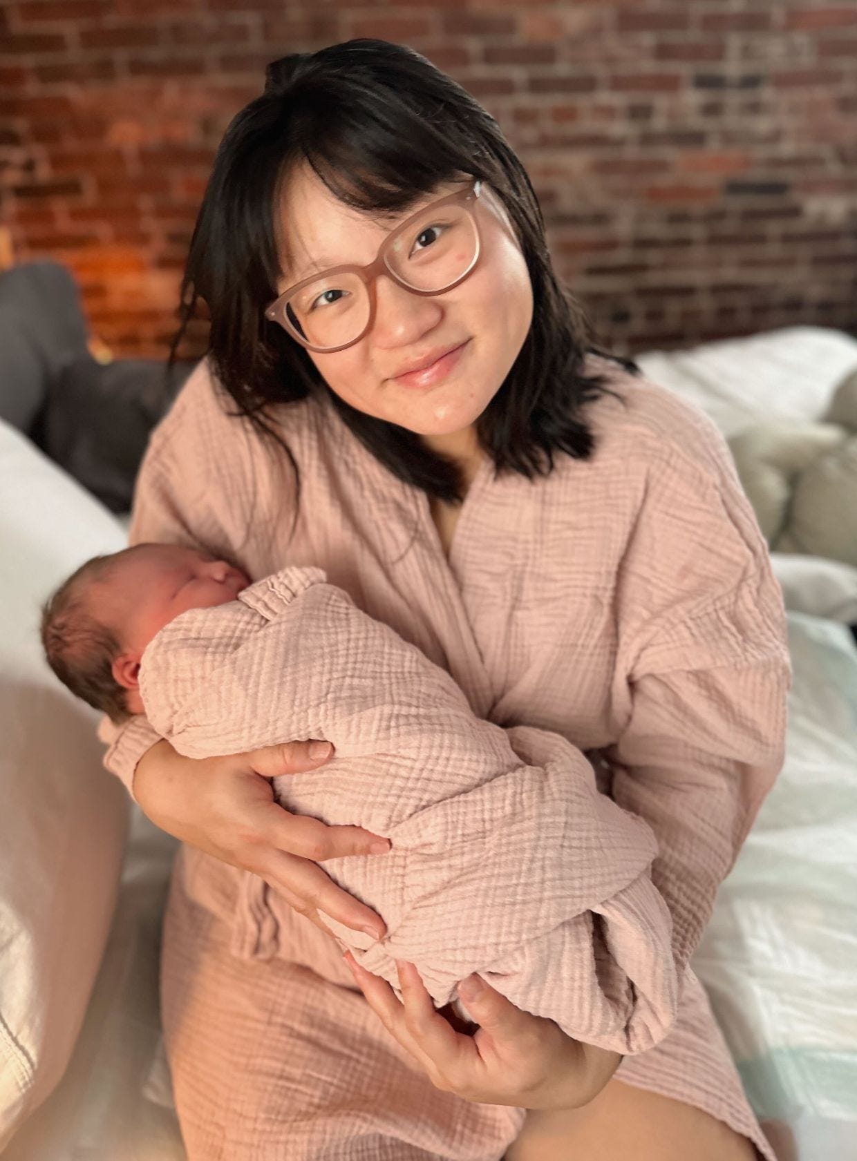 Katelin Potter-Rivera poses for a photo while holding her baby.