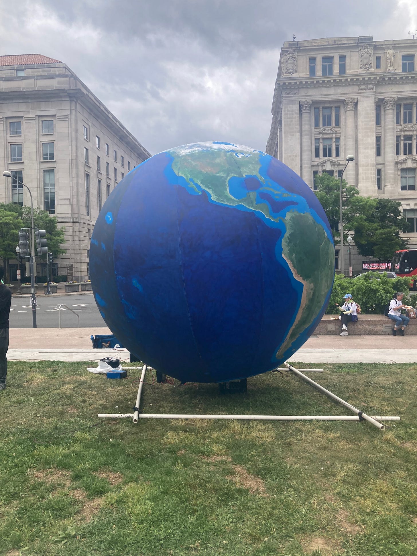 Photo of a giant blow-up globe with stone buildings in the background