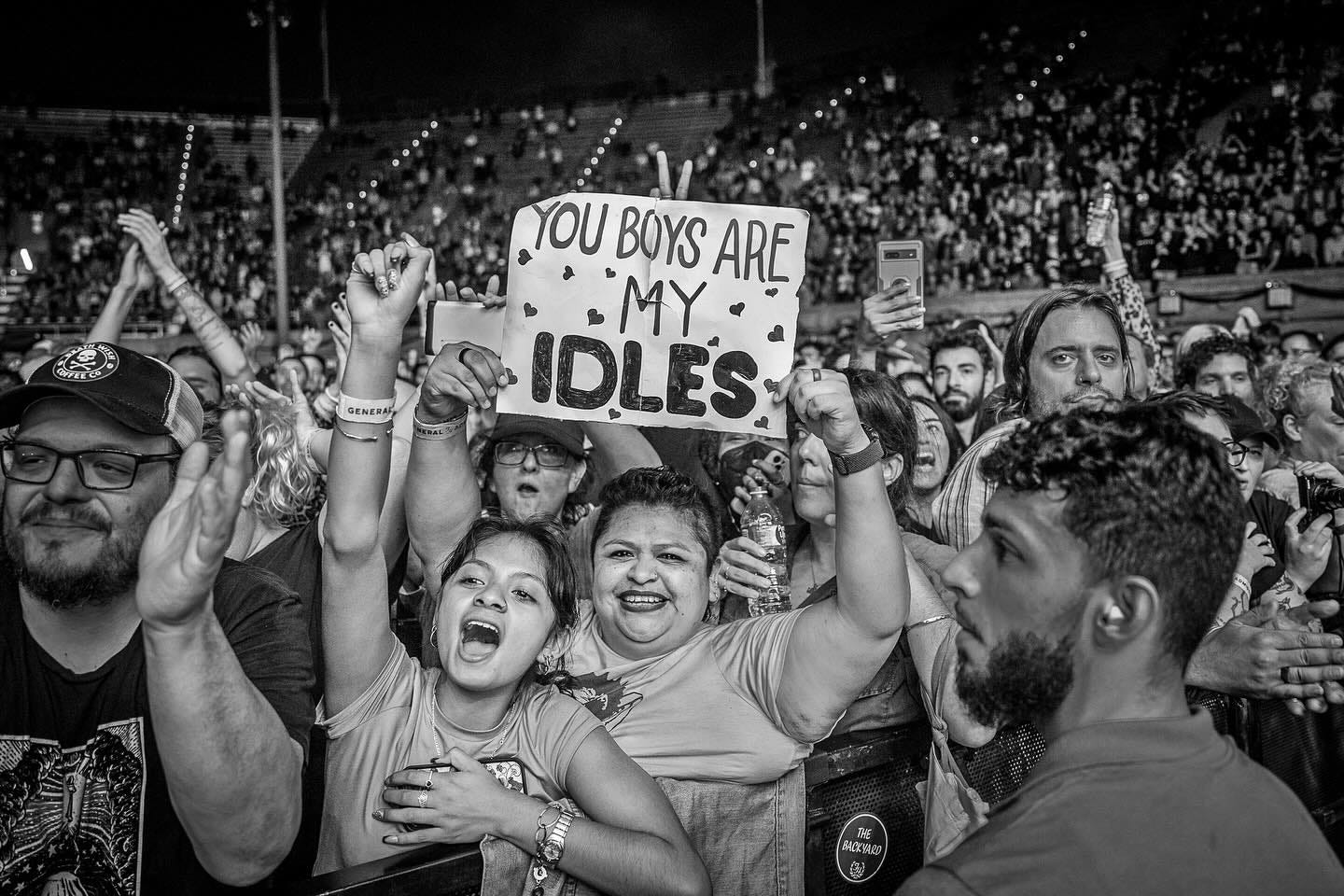 May be a black-and-white image of 4 people, crowd and text