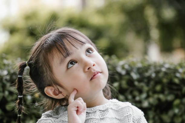 Beautiful kid playing Thinker with serious Portrait, pigtails, thinking, planning, positive emotion, Ideas, Inspiration, creativity, studying, learning, garden, nature, Asian and Indian Ethnicities child thinking stock pictures, royalty-free photos & images