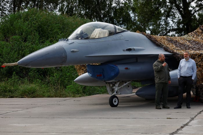 Ukrainian Defence Minister Rustem Umerov and Secretary of Ukraine's National Security and Defence Council Oleksandr Lytvynenko stand next to an F-16 fighting aircraft of the Ukrainian Air Forces, amid Russia's attack on Ukraine, in an undisclosed location, Ukraine August 4, 2024.