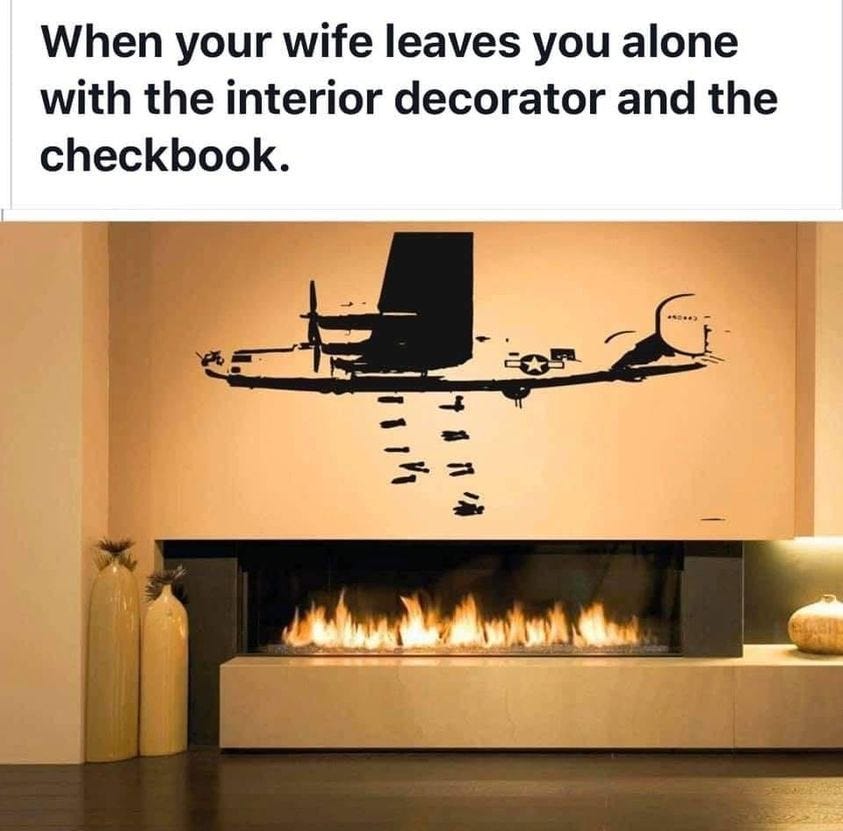 When your wife leaves you alone with the interior decorator and the checkbook.
Photo of fireplace with high contrast stencil of a B-24 Liberator bomber releasing its payload over the fireplace opening with a fire going.