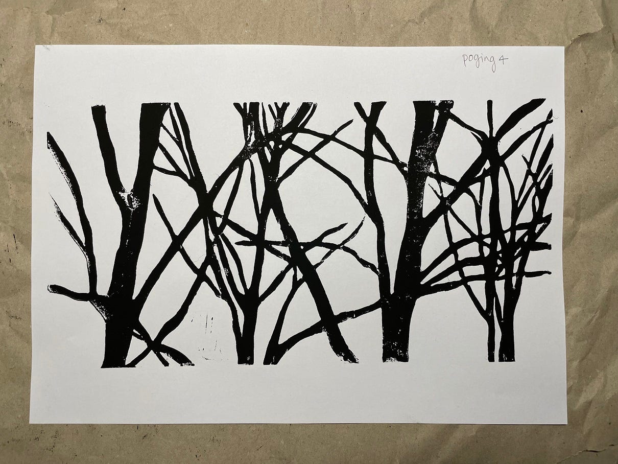 Photo of a linocut of trees in black ink, with a very small amount of background noise