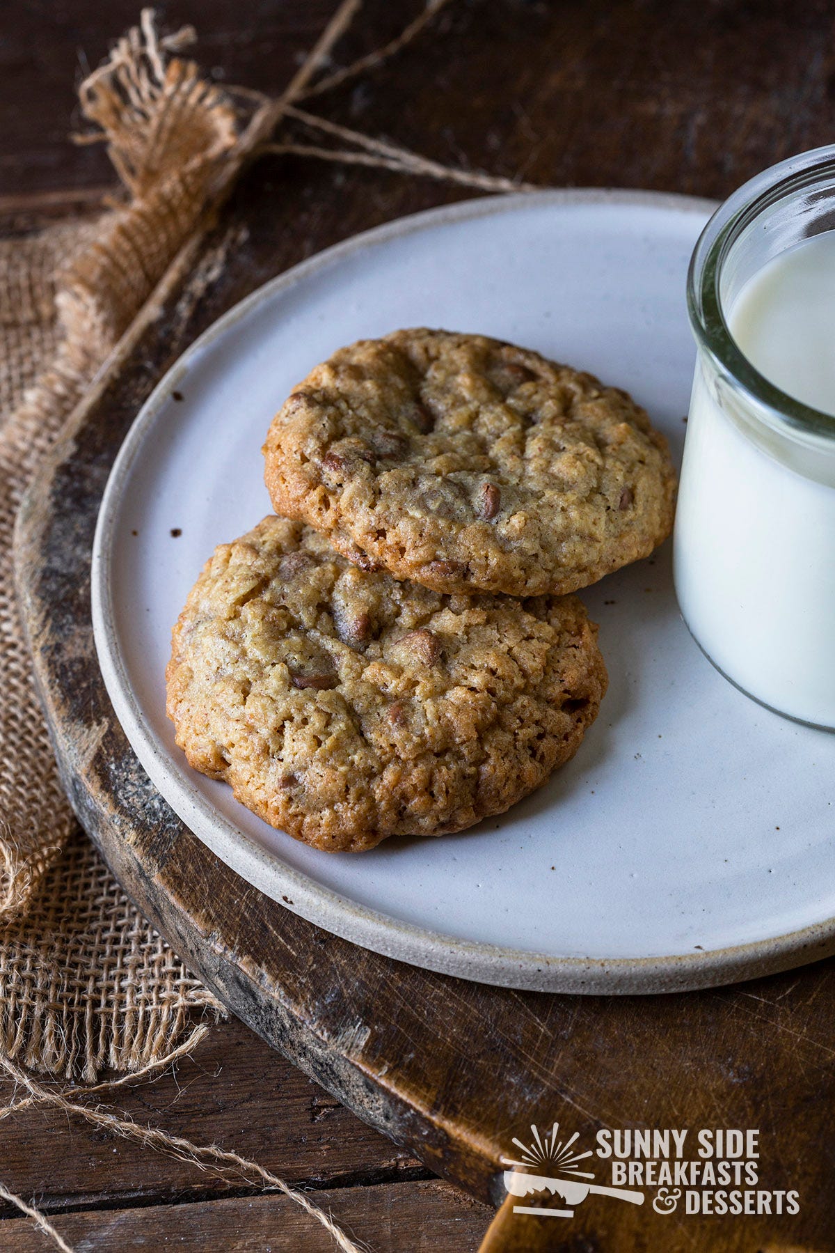 Two cookies with a glass of milk.