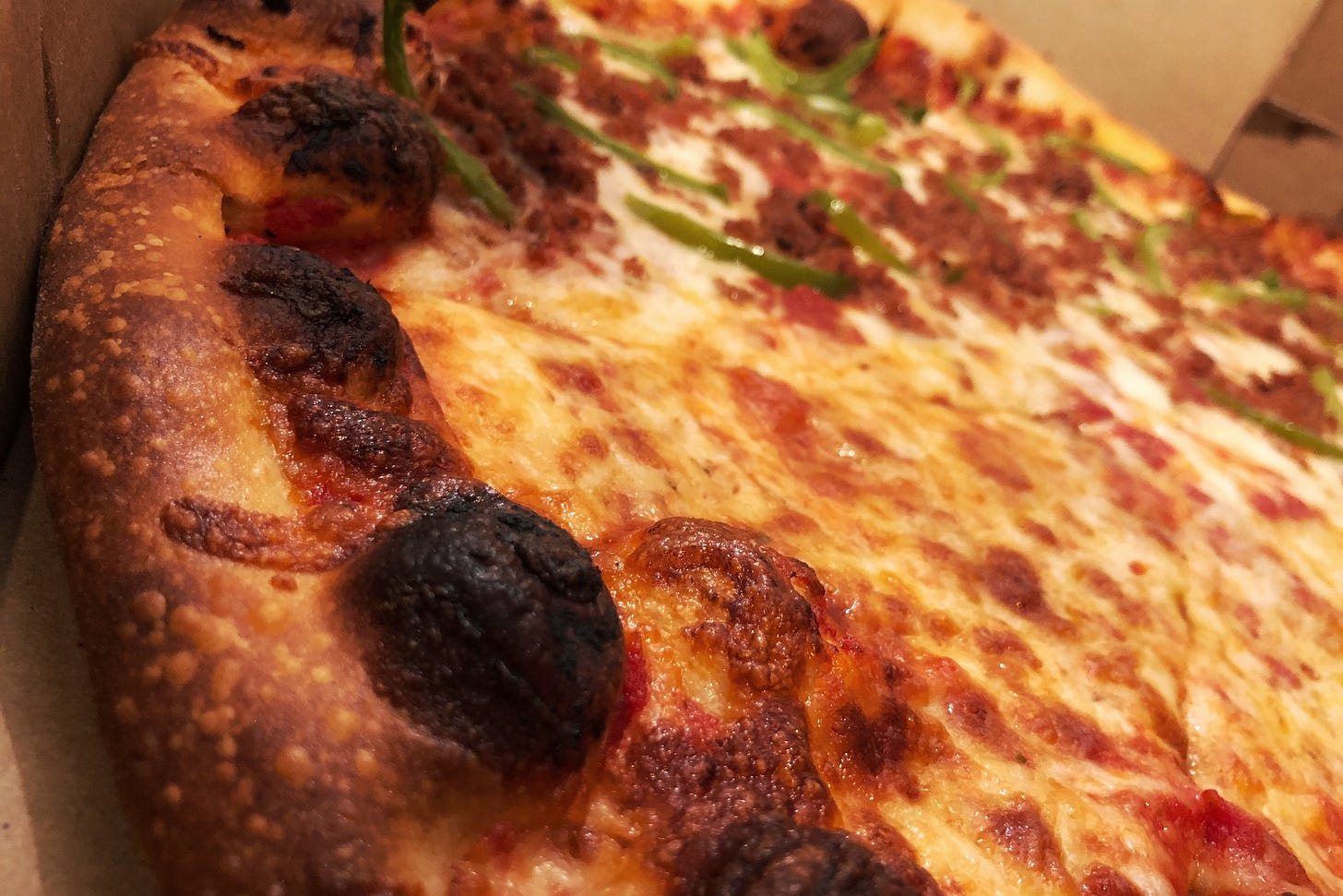 Above you can see a practically perfect in every way pizza. The crust is the right kind of brown, charred in the right spots, and you have an even layer of cheese that covers the sauce just so.&nbsp;