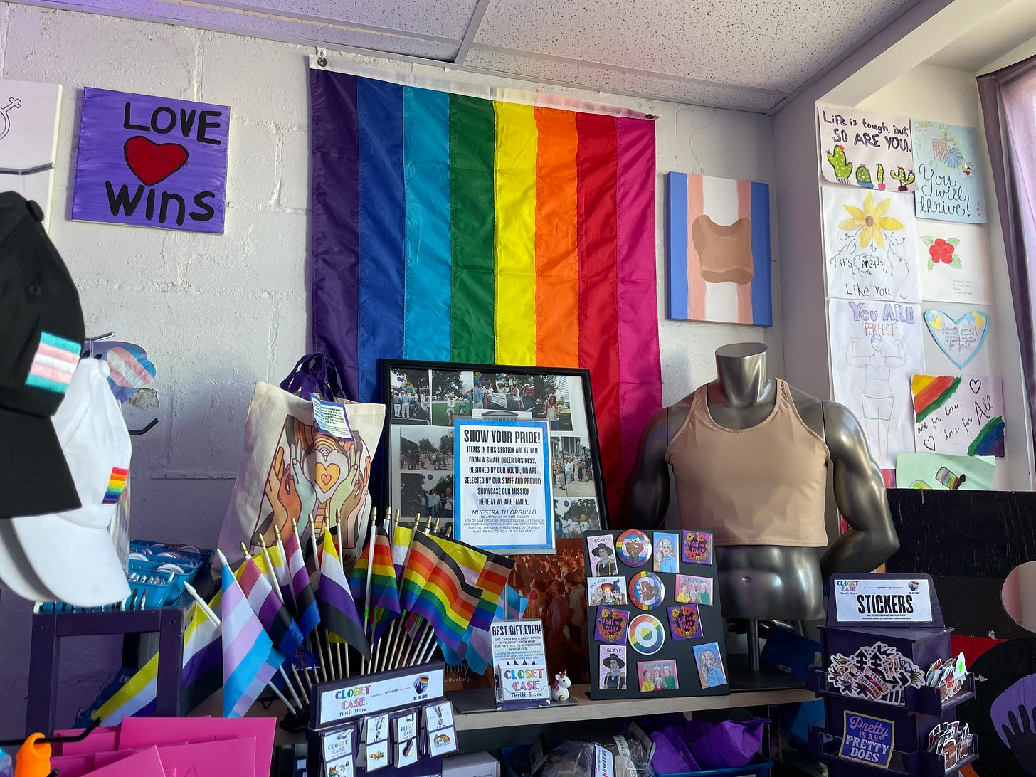 A photo of the pride flags, decorations, pins and gender-affirming items that are sold in the front of Closet Case Thrift Store. A photo of the pride flags, decorations, pins and gender-affirming items that are sold in the front of Closet Case Thrift Store.