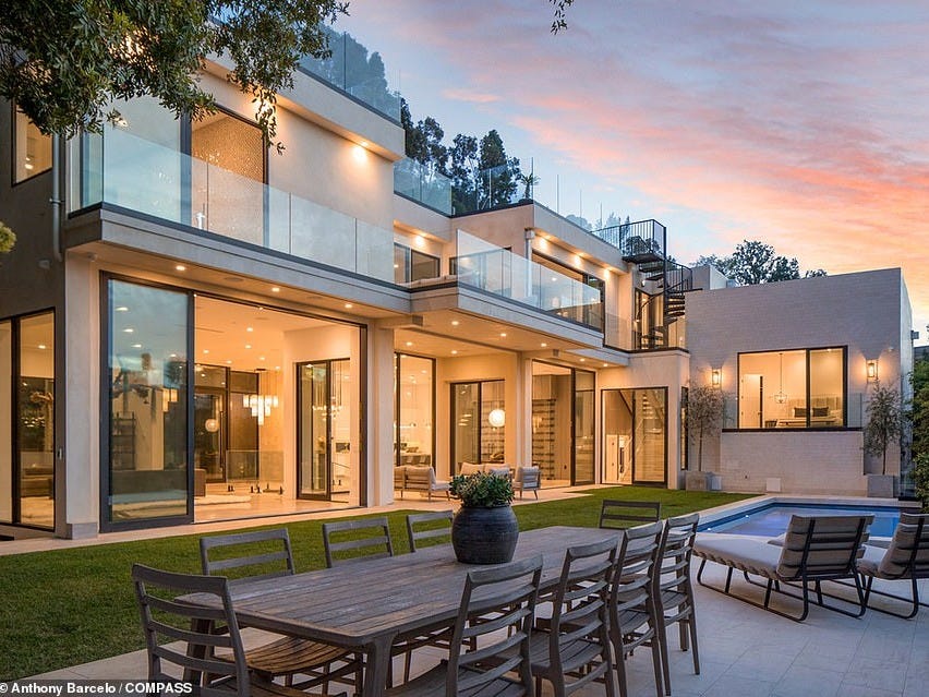 Spectacular: The five-bedroom home is covered in enormous glass windows which allows swathes of natural light into the rooms and ensure the idyllic views can be seen from several rooms in the house