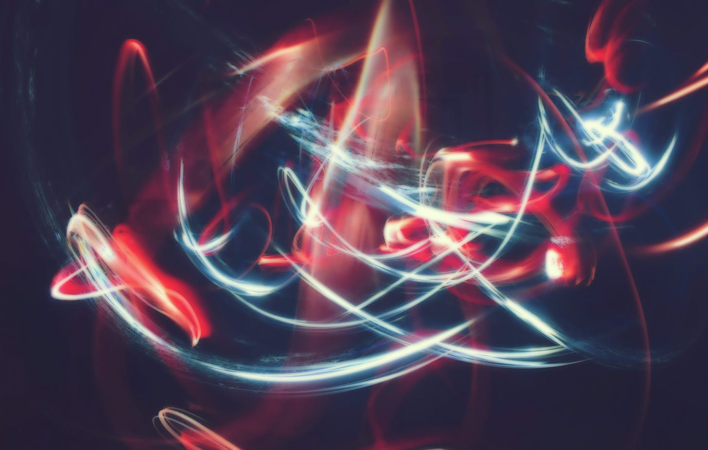 Swirling red and white lights by Admad Dirini on Unsplash.