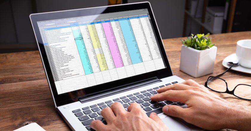 Person using laptop and excel