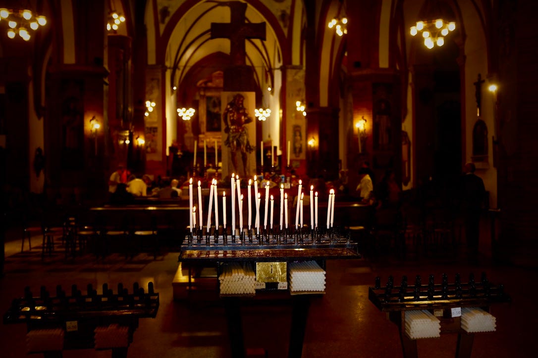 A group of candles in a church

AI-generated content may be incorrect.