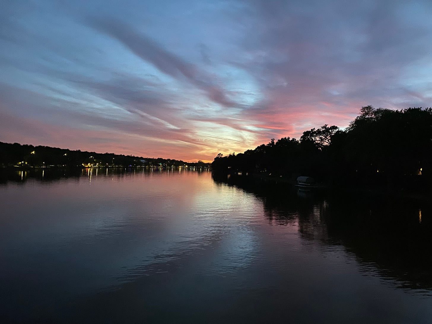 sunset over a river, sky is blue, pink, and purple