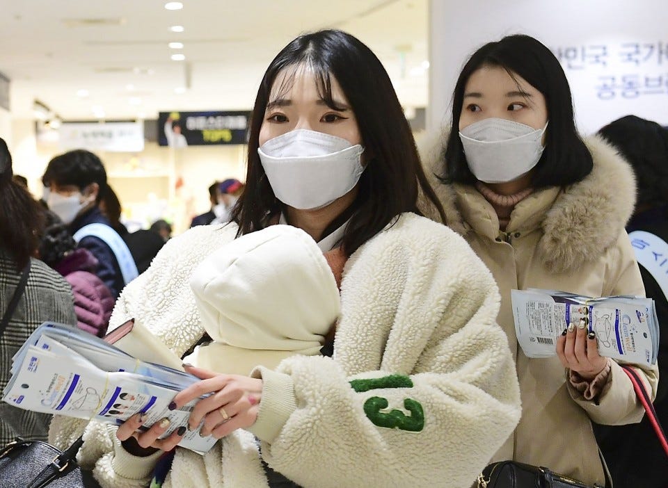 South Korea rations face masks as virus cases near 7,400