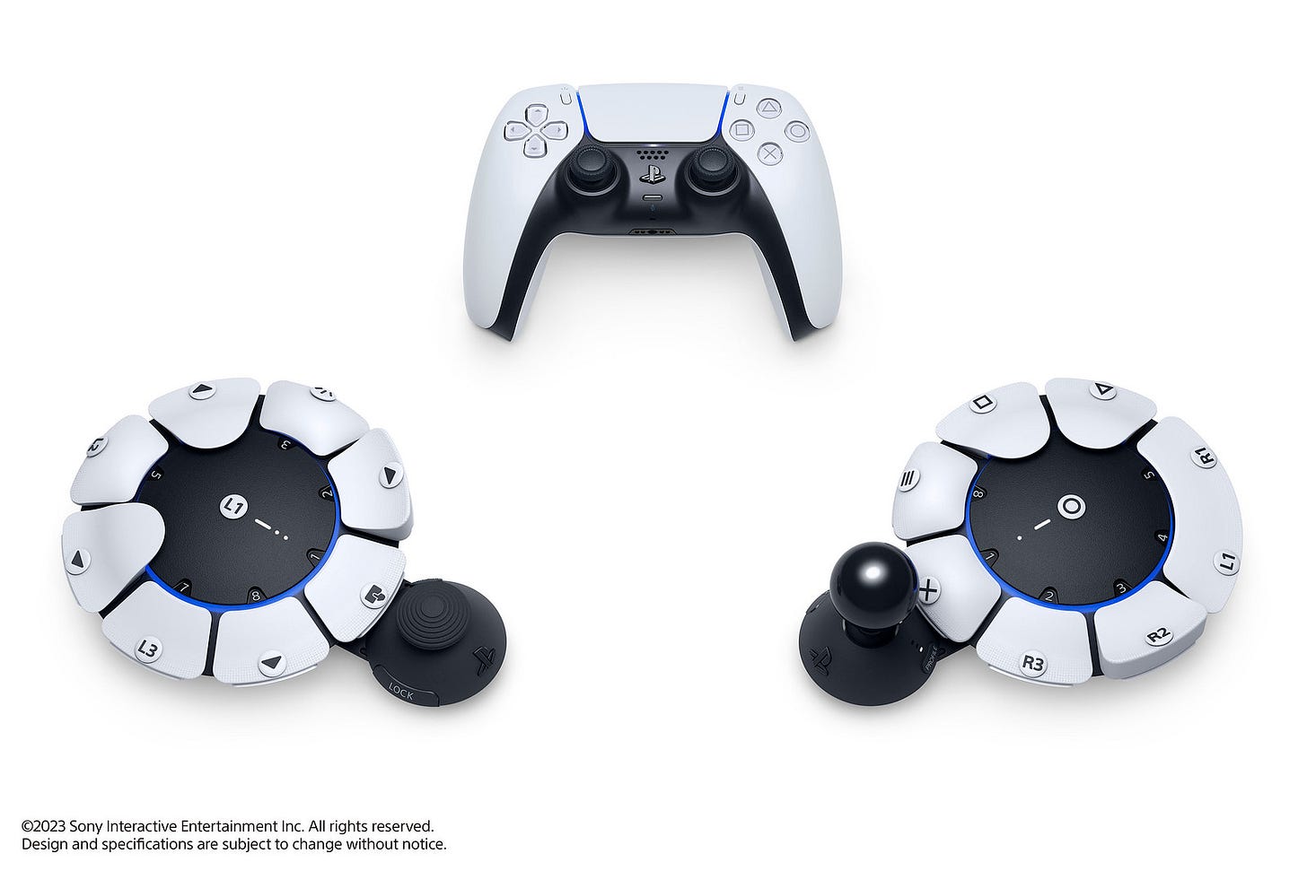 A close-up shot of the Playstation Access™ controller. The controller features several buttons, including a directional pad, a joystick, and multiple action buttons. The buttons are facing the viewer, and the background is blurred, creating a sense of depth.