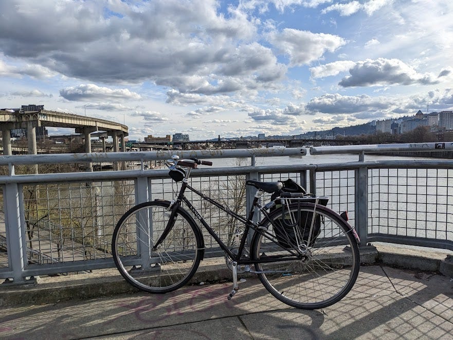 a bike sitting against a bridge on a cloudy pleasant day