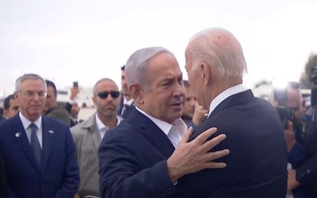 Prime Minister Benjamin Netanyahu and US President Joe Biden hugging at Ben Gurion airport on October 18, 2023.  (screen capture)