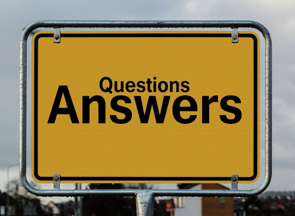 Free Yellow sign with text questions and answers suggesting direction in decision-making. Stock Photo