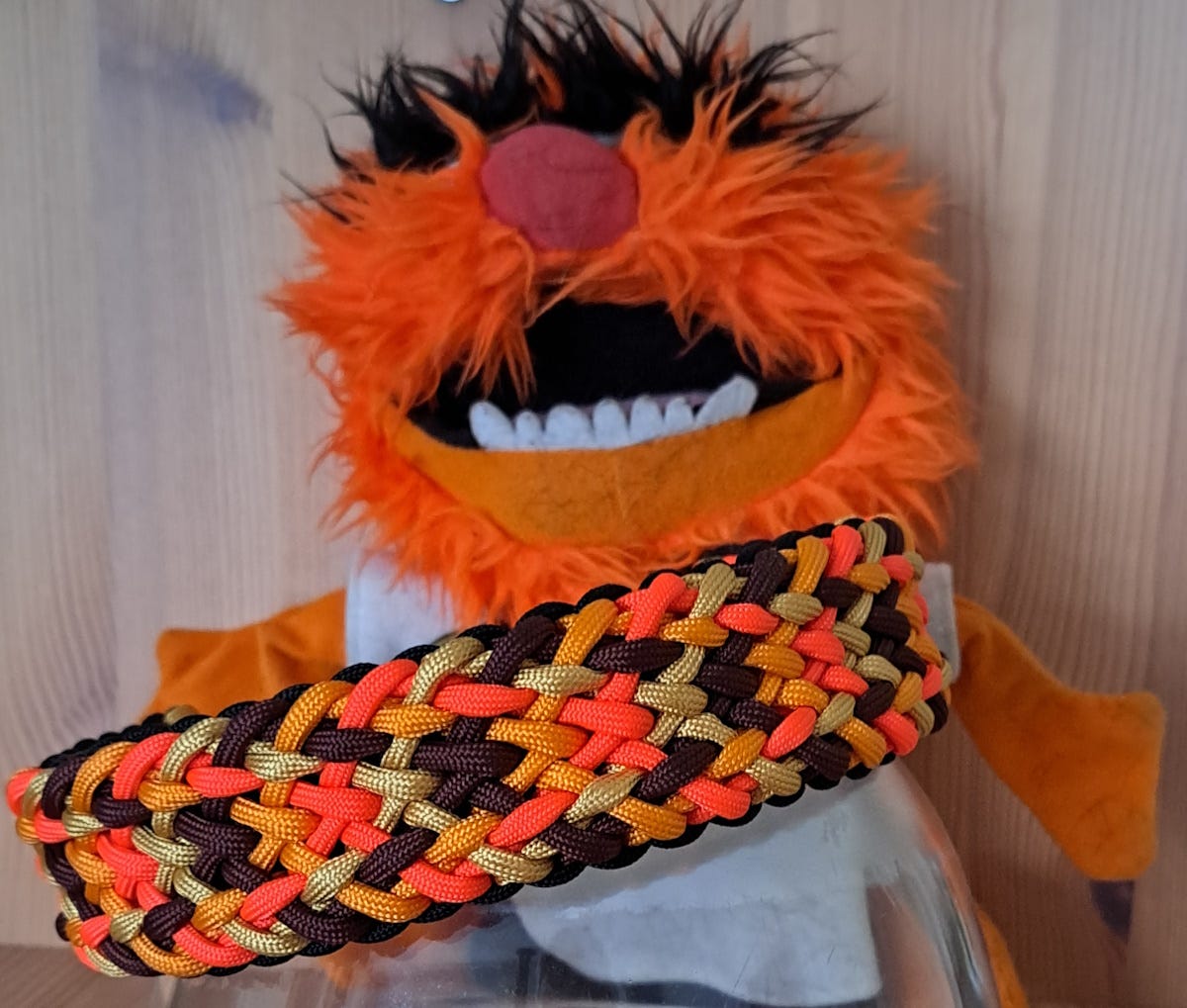 Knotted dog collar with Animal hand puppet (Muppets) behind it