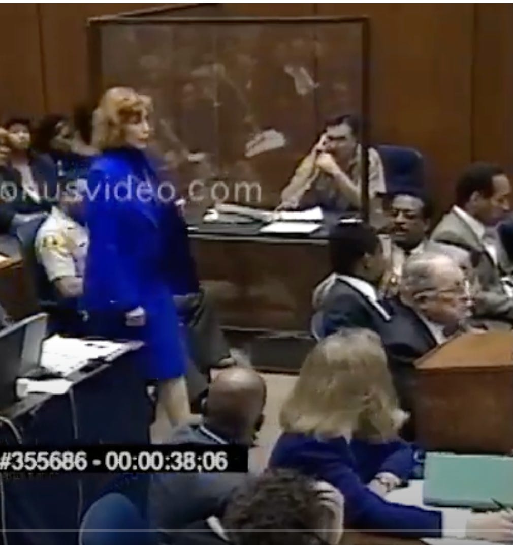 Maya Hamburger, dressed in a royal blue suit, walks into the courtroom as part of the OJ Simpson and Johnnie Cochran team