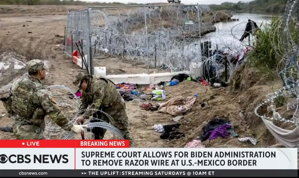 Texas National Guard soldiers install rolls of concertina wire along the banks of the Rio Grande; clothing discarded by migrants is strewn along the ground