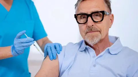 Getty Images Man getting vaccinated