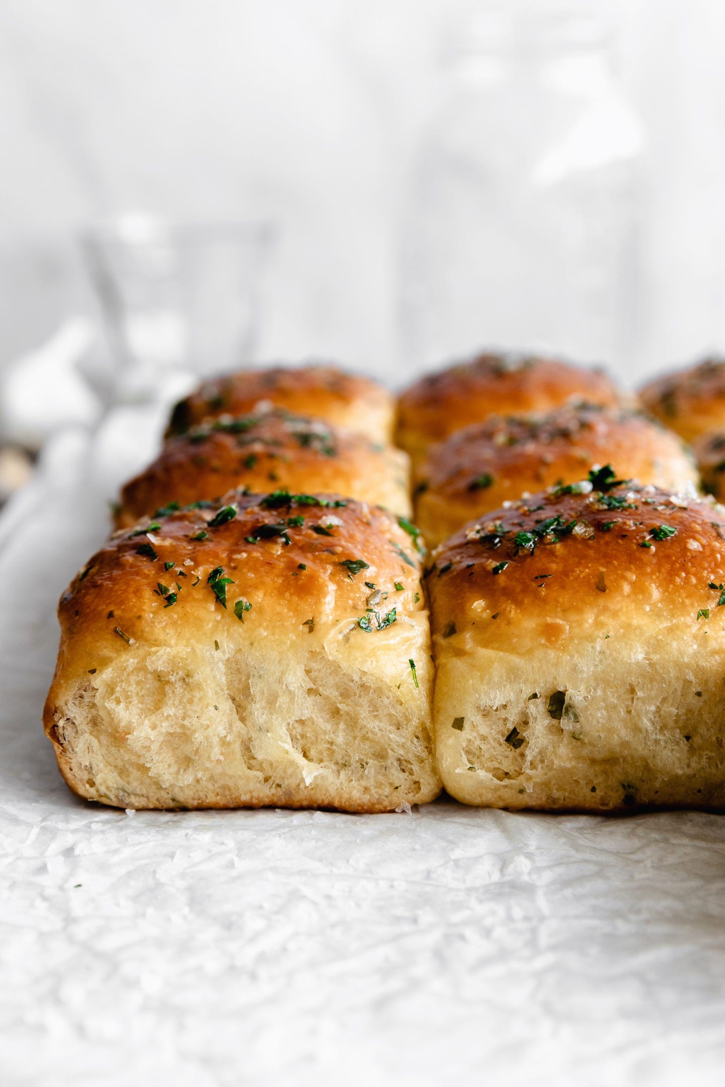 Vegan roasted garlic and herb brioche buns seen from the side