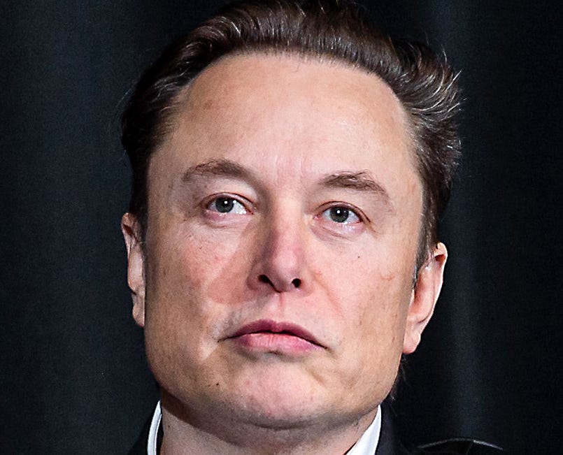 Elon Musk, a middle aged white man, starting off into the distance.