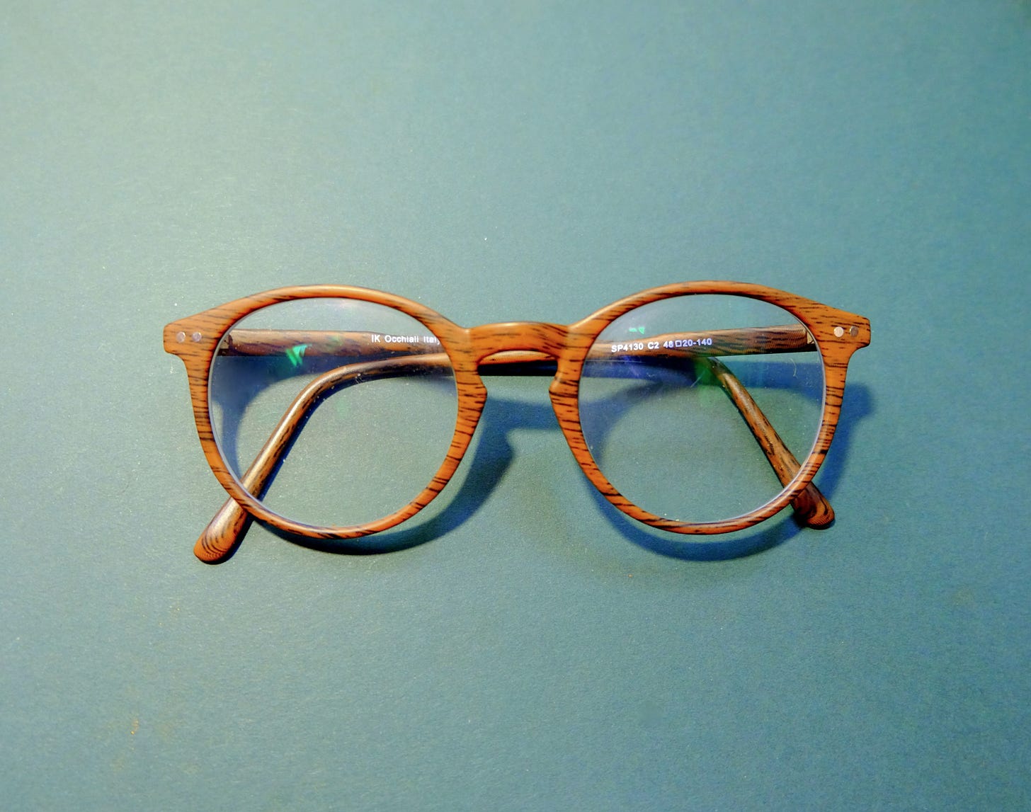 wood grain glasses on a green background