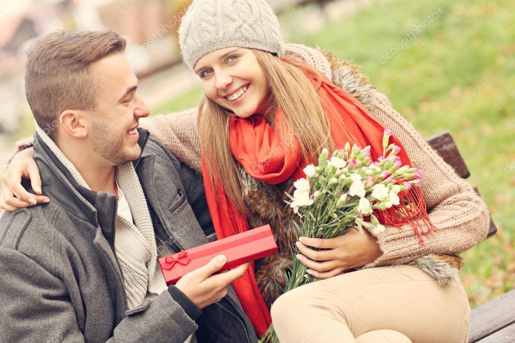 Romantic couple with presents in park Stock Photo by ©macniak 102322888