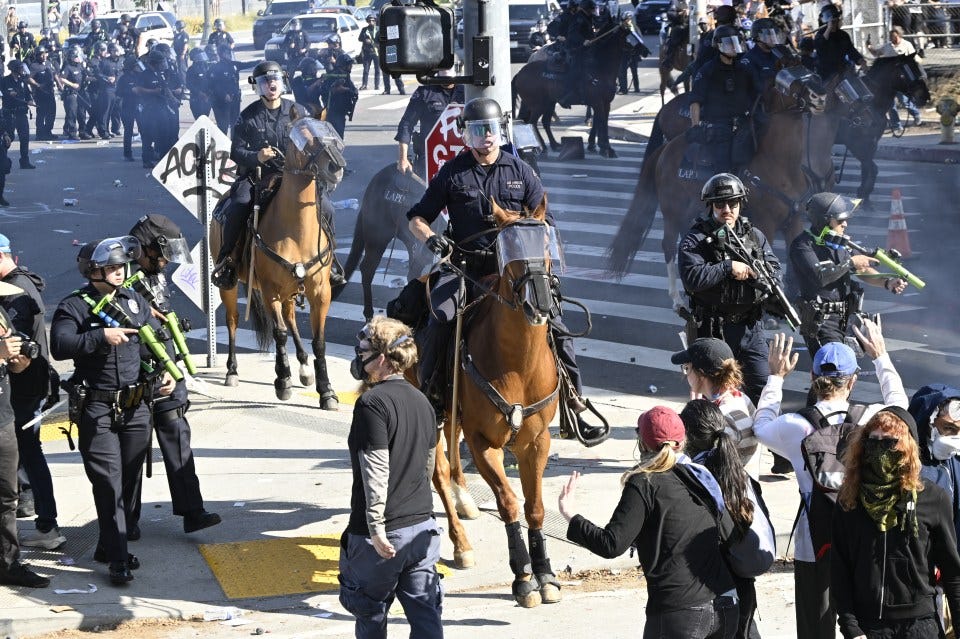 Mounted police clash with demonstrators during immigration protests.