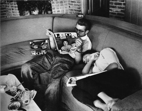 James Dean Sitting on a Couch Reading Look Magazine with Elizabeth Taylor napping beside him.