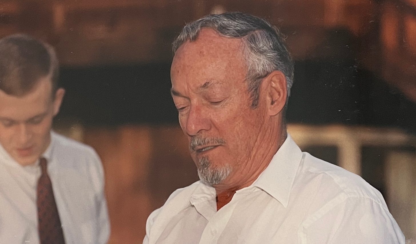 photo of an older man with a white collared shirt