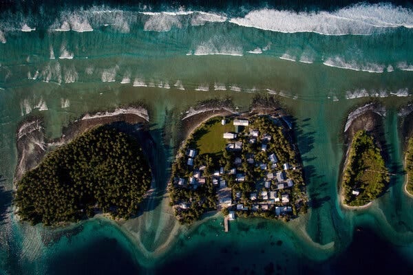 An overhead shot of three islands, with many houses clustered on the middle island.