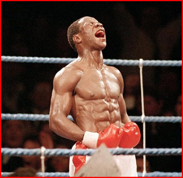 An image of Chris Eubank, British Boxer, standing victorious in the boxing ring. He’s screaming out in utter joy.