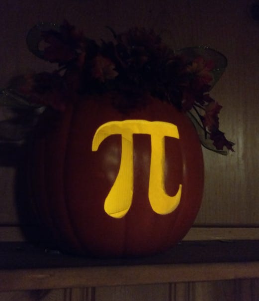 A craft pumpkin with a glowing pi symbol.