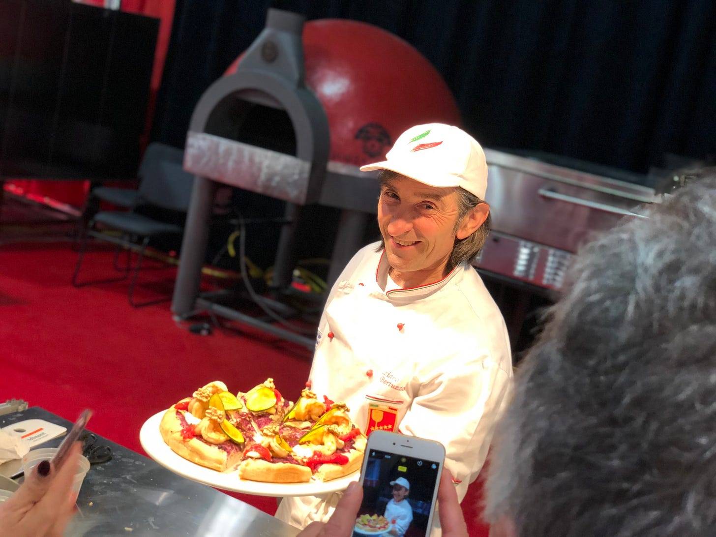 Graziano Bertucco showing off a pizza he made that's engineered to reduce starch.