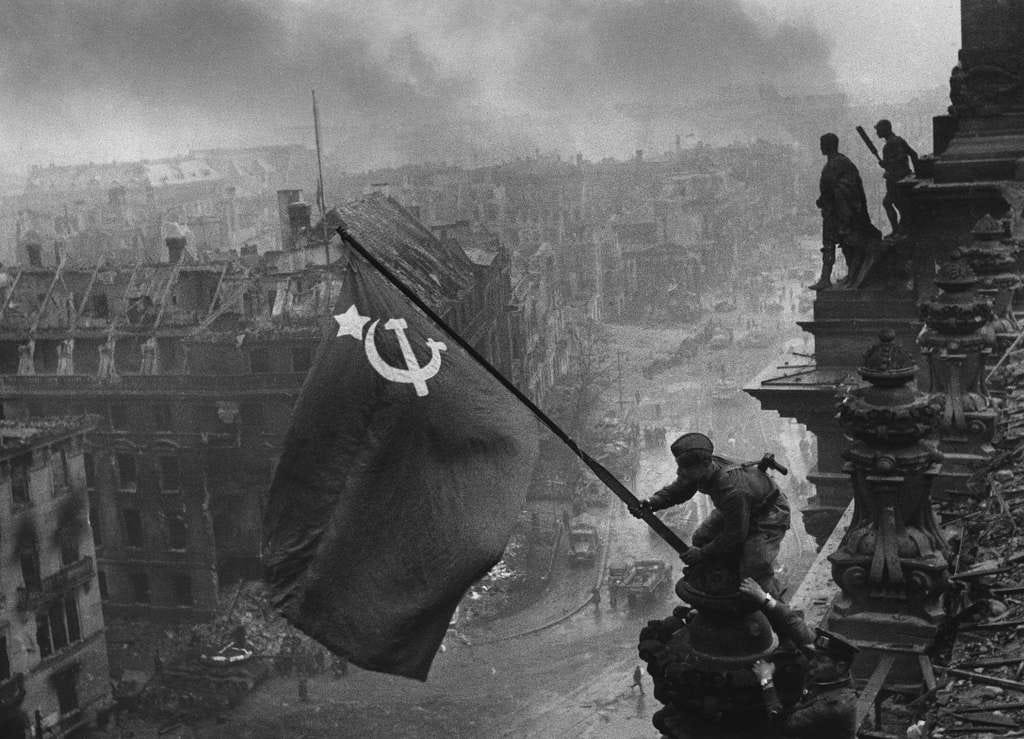 The iconic photograph by Yevgeny Khaldei of Red Army soldiers mounting a Soviet flag on the Reichstag in Berlin