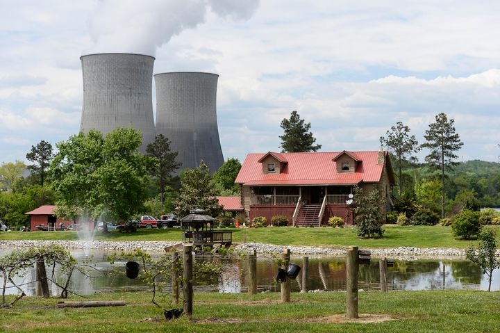 In this April 29, 2015 photo, a home sits within view of the Watts Bar Nuclear Plant cooling towers Unit 1, left, and Unit 2 near Spring City, Tenn. 