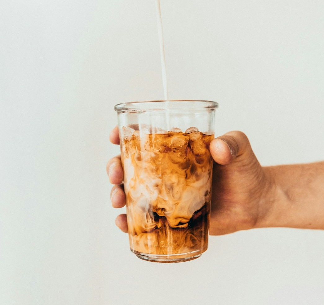 clear drinking glass with brown liquid clear drinking glass with brown liquid