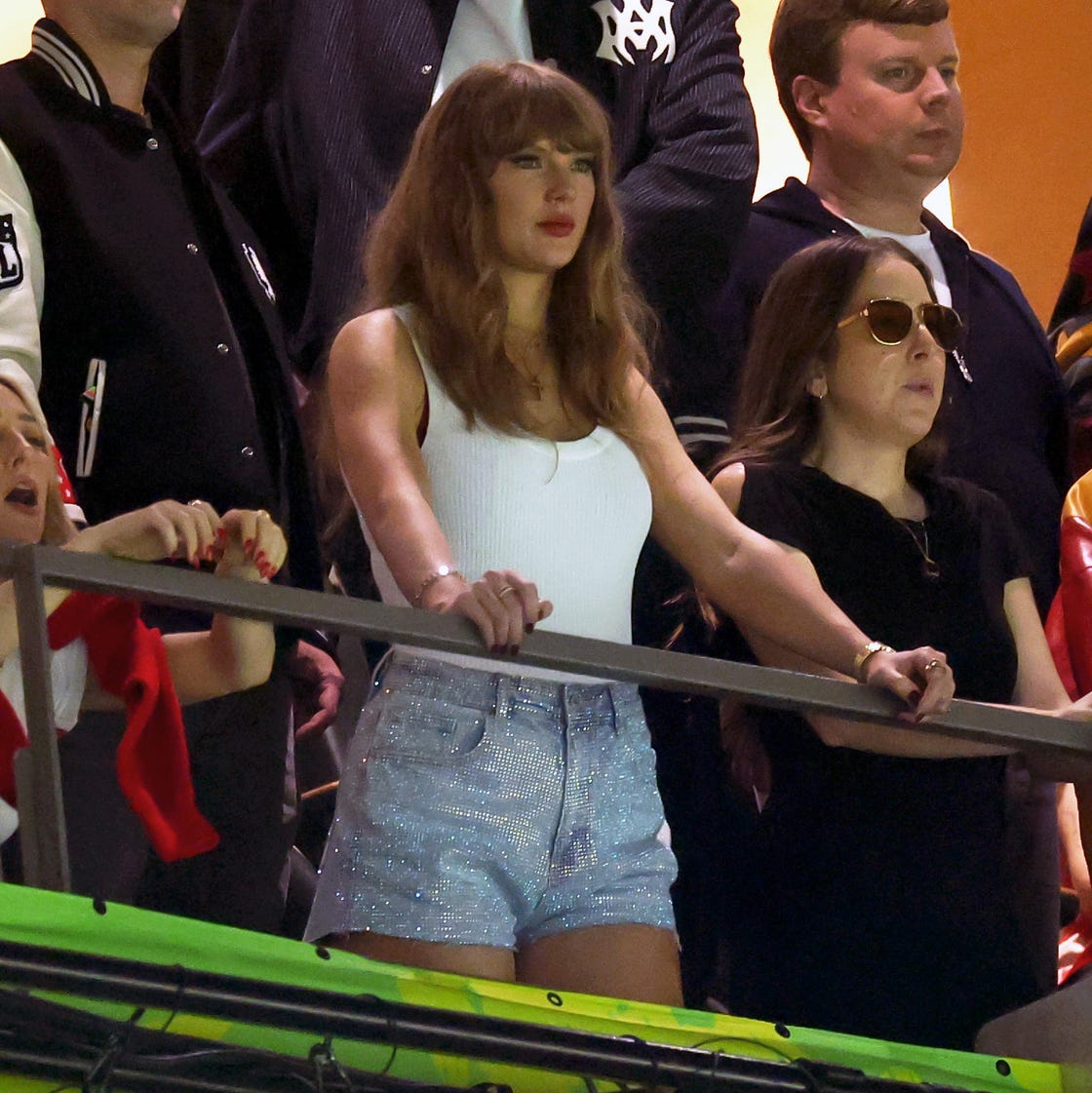 Taylor Swift Arrives in a White Blazer, 'T' Chain, and Daisy Dukes to 2025  Super Bowl