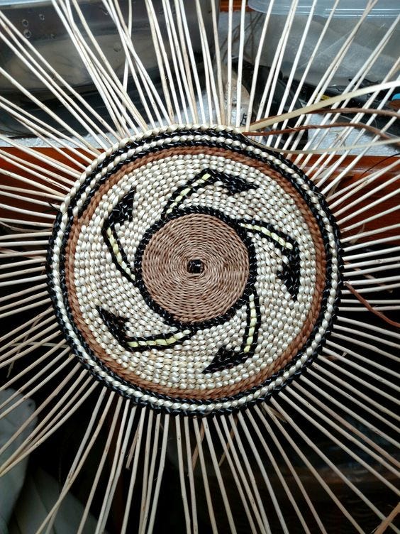 weaving a basket hat with various natural materials, by Karuk weaver Denna Dodds weaving a basket hat with various natural materials, by Karuk weaver Denna Dodds