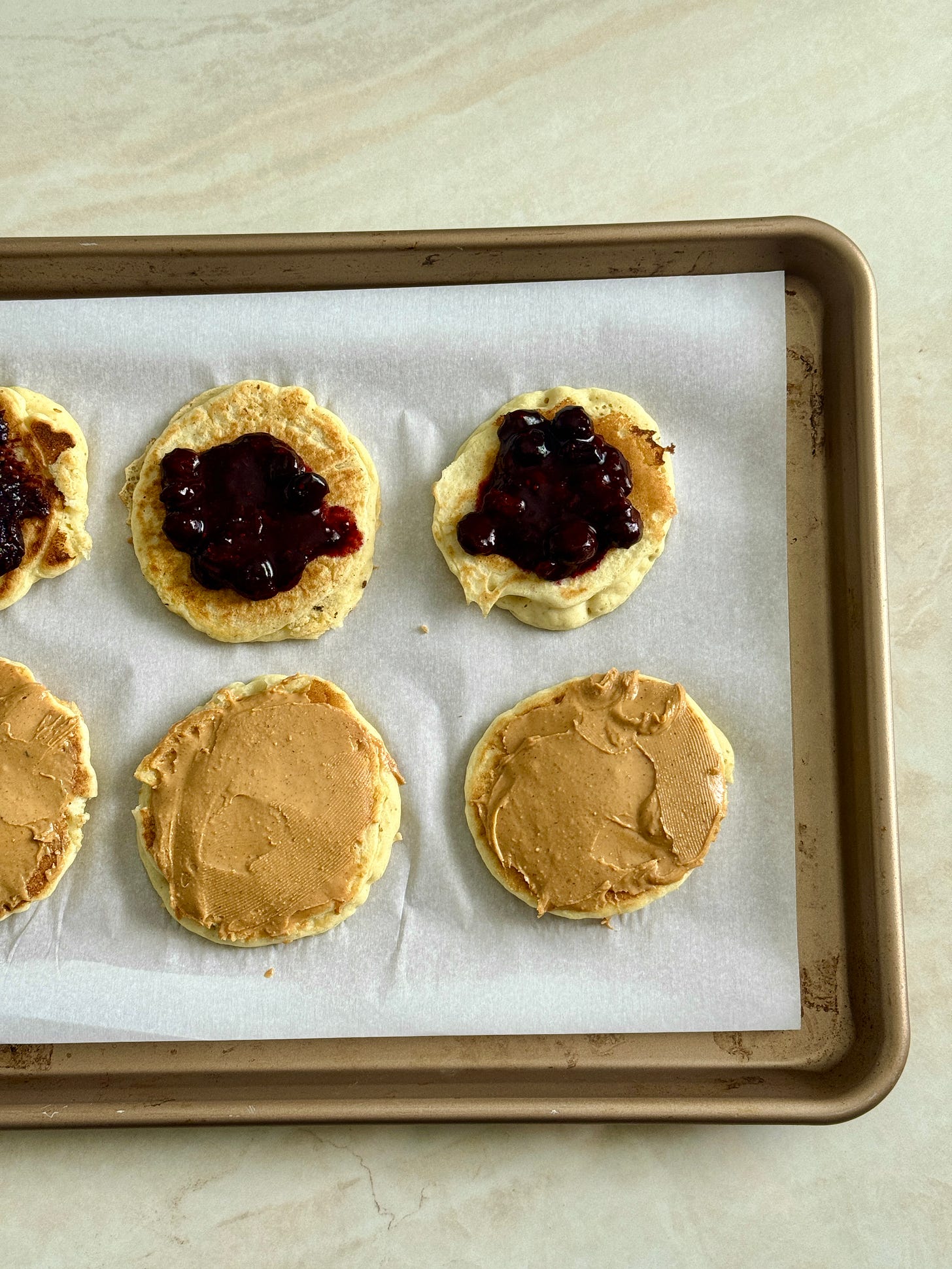 Fluffy gluten-free pancakes layered with creamy peanut butter and warm blueberry compote, stacked into satisfying breakfast sandwiches prepped ahead of time