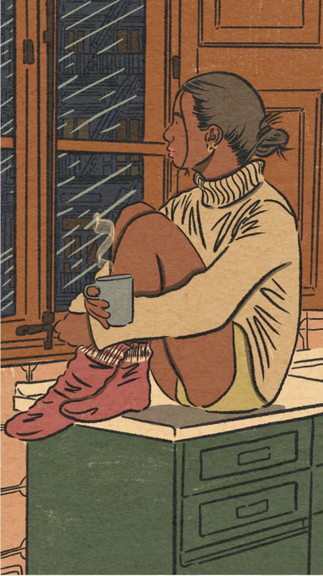 An illustration of a brown femme is sitting on a countertop with their knees hiked up to their chest. They fold their arms over their legs while holding a warm drink. They're wearing a tan colored turtleneck, shorts, and burgundy slouchy socks. They are looking out at the window as the rain pours down