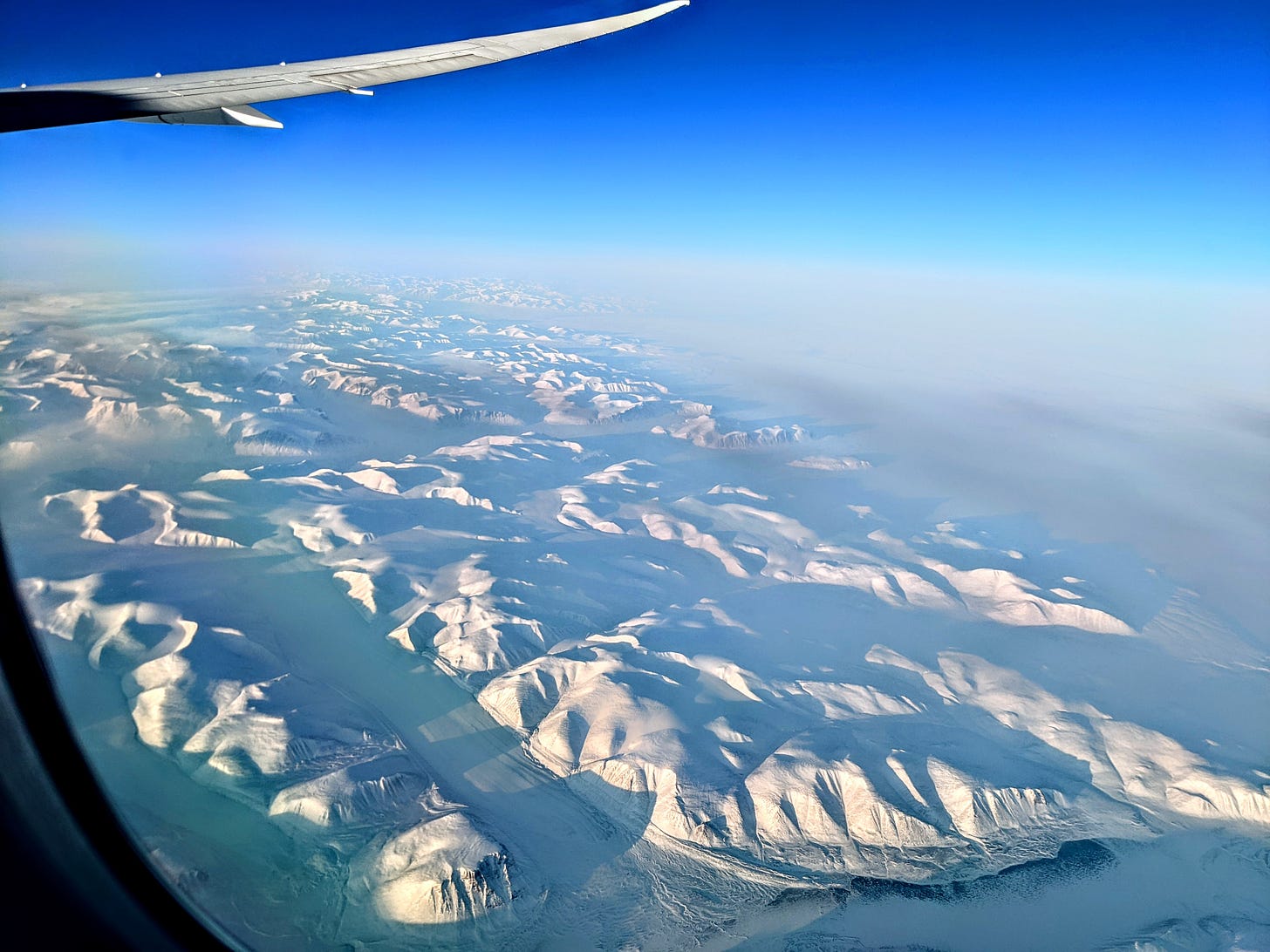 A snow-covered Greenland from an airplane. 
