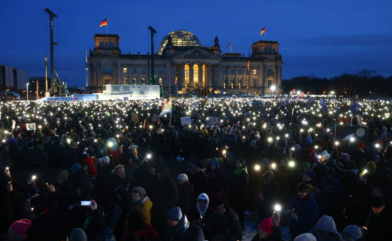 Participants shine lights from their phones during a demonstration against racism and far-right politics in front of the Reichstag building in Berlin, on Sunday. (Christian Mang/AFP/Getty Images) (AFP Contributor#AFP/AFP/Getty Images)