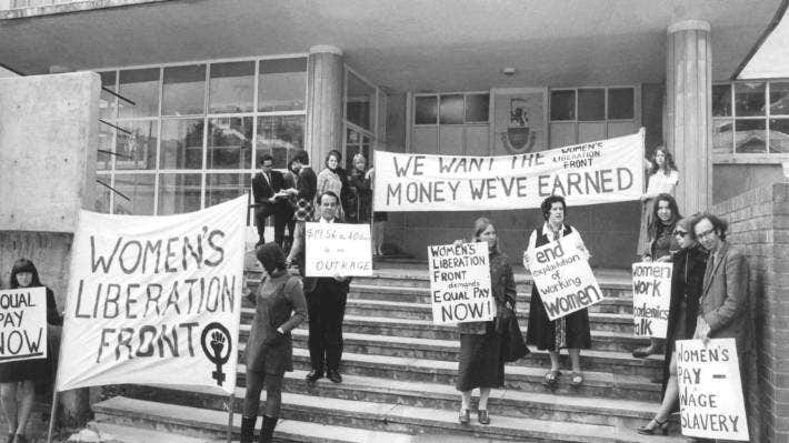 The Women’s Liberation Front at Victoria University of Wellington in 1970 demonstrates for equal pay outside the university industrial relations centre inaugural seminar on equal pay.