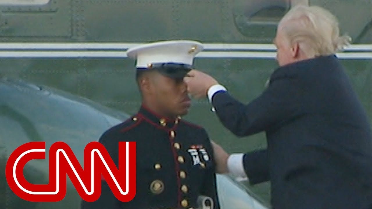 Trump lends hand to Marine whose hat blew away - YouTube