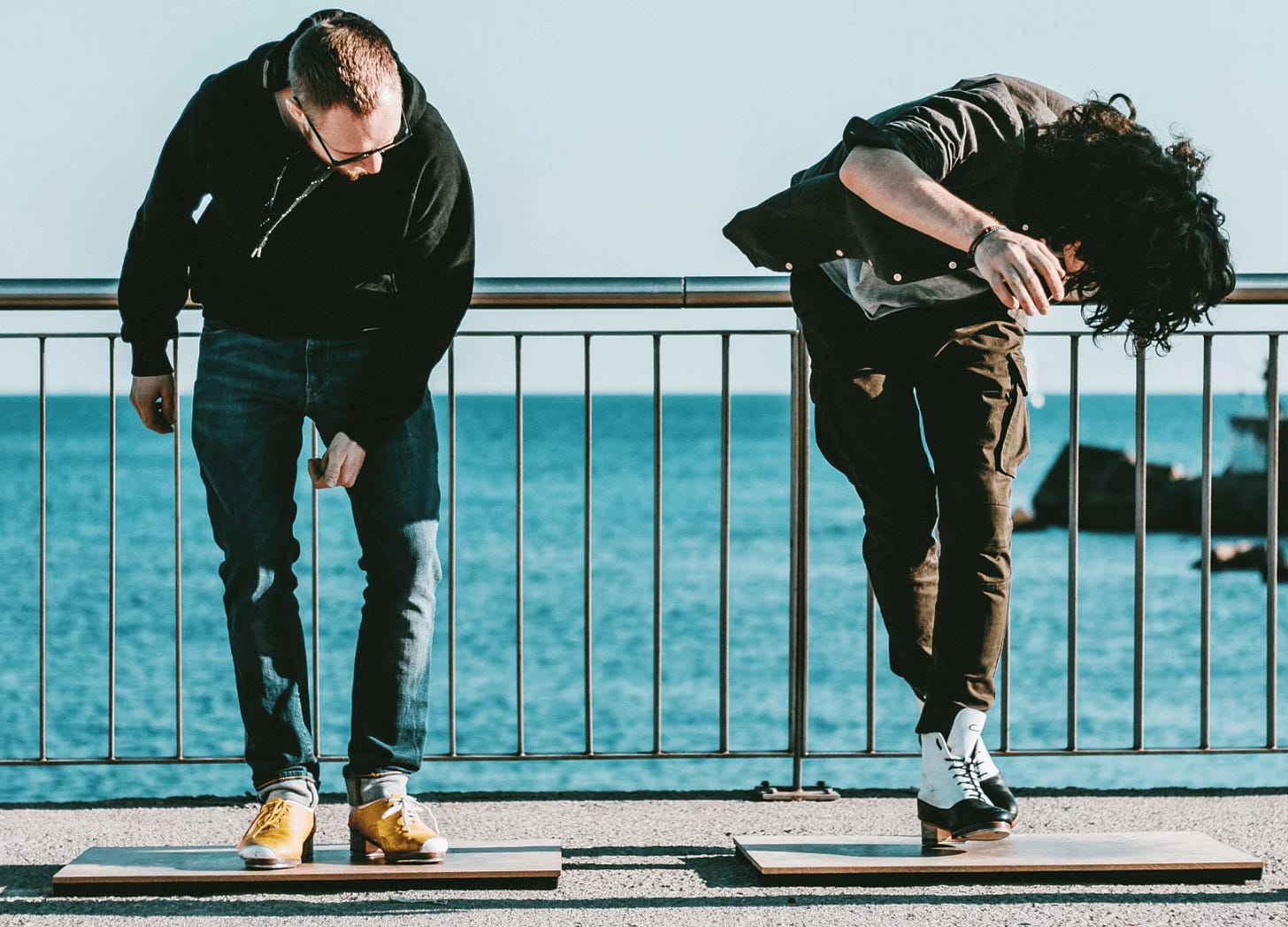 Two man tap dancing on the waterfront