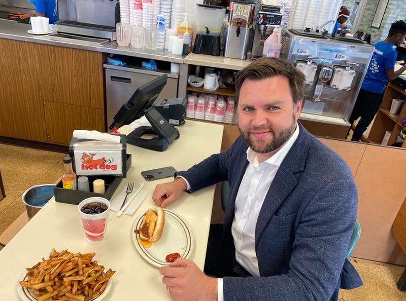 Vance pretending to be normal in a fast food restaurant 2022 campaign photo.