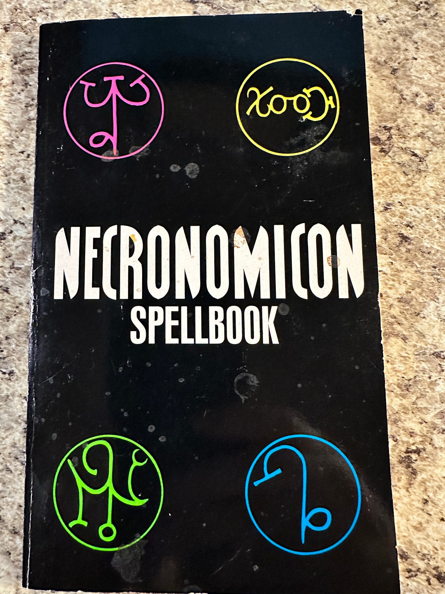 A dirty, used copy of the "Necronomicon Spellbook" paperback