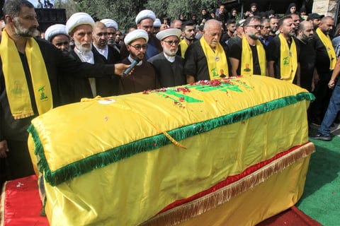 Mourners pray before the coffin during the funeral of a member of Hezbollah who was killed the previous day by the explosion of a communication device (Photo | AFP)